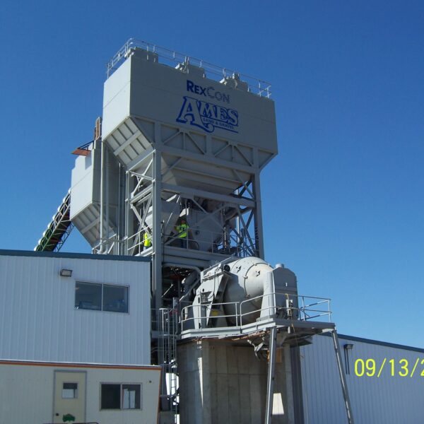A large industrial concrete batching plant labeled REXCON AMES stands beside a white building under a clear blue sky. The date stamp on the photo reads 09/13/2006.